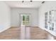 Bright living room with wood floors and french doors leading to a balcony at 15906 Prince William Pl, Odessa, FL 33556