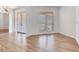 Living room featuring light wood flooring, large window, and a glimpse of the foyer at 15906 Prince William Pl, Odessa, FL 33556