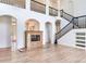 Bright, open living area with a modern fireplace, staircase, and high ceilings for a grand feel at 15906 Prince William Pl, Odessa, FL 33556