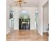 Bright living room featuring an archway, fireplace, wood floors, and modern light fixture at 15906 Prince William Pl, Odessa, FL 33556