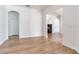 Living room featuring light wood flooring, and archways to other rooms at 15906 Prince William Pl, Odessa, FL 33556