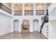 Bright living room with high ceilings, arched openings, and a modern fireplace creating a welcoming space at 15906 Prince William Pl, Odessa, FL 33556