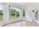 Bright living room with large windows and a view of the surrounding landscape at 15906 Prince William Pl, Odessa, FL 33556