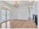 Bright and airy living room with wood floors and arched doorways, featuring an ornate light fixture at 15906 Prince William Pl, Odessa, FL 33556