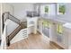 Bright living room showcasing wood floors, large windows, and open concept design with staircase at 15906 Prince William Pl, Odessa, FL 33556