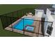 A luxurious backyard featuring a pool and hot tub, complemented by an inviting outdoor seating area behind a secure black fence at 15906 Prince William Pl, Odessa, FL 33556