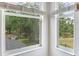 View from inside featuring windows overlooking pond and lush greenery at 15906 Prince William Pl, Odessa, FL 33556