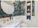 Charming bathroom with decorative wallpaper, modern fixtures, and storage shelves at 1700 Beachway Ln, Odessa, FL 33556