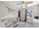This Bedroom features neutral paint and carpet, a ceiling fan, and a view to the outdoors at 1700 Beachway Ln, Odessa, FL 33556
