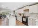 Bright kitchen with lake view, white cabinets, and marble countertops at 1700 Beachway Ln, Odessa, FL 33556