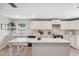 Bright kitchen with white cabinets, large island and stone countertops at 1700 Beachway Ln, Odessa, FL 33556