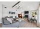 Bright open concept living room features hardwood floors, vaulted ceilings, and a beautiful fireplace at 1700 Beachway Ln, Odessa, FL 33556