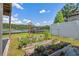 The backyard has a garden with herbs and a lake view with a dock and boat house at 1700 Beachway Ln, Odessa, FL 33556