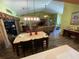 Dining room features wood flooring, stylish table, and views to the living room at 18027 Baywood Forest Dr, Hudson, FL 34667