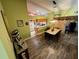 Dining room with wood flooring, stylish table, and view to kitchen at 18027 Baywood Forest Dr, Hudson, FL 34667