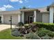 Charming single-story home featuring a landscaped front yard and covered entryway at 18027 Baywood Forest Dr, Hudson, FL 34667