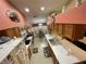 Traditional kitchen featuring tile flooring, wood cabinets, and stainless steel appliances at 18027 Baywood Forest Dr, Hudson, FL 34667