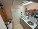 This laundry room has a washer, a dryer, and storage at 18027 Baywood Forest Dr, Hudson, FL 34667