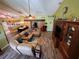 View of the living room with wood flooring, high ceilings, and a leather sofa at 18027 Baywood Forest Dr, Hudson, FL 34667