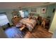 Bright main bedroom featuring wood floors, ceiling fan, and a walk-in closet at 18027 Baywood Forest Dr, Hudson, FL 34667
