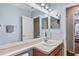 Bathroom with a single vanity, and a doorway leading into an additional bathroom at 18061 Glastonbury Ln, Land O Lakes, FL 34638