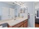 Bathroom featuring dual sinks with cabinetry, and large mirror at 18061 Glastonbury Ln, Land O Lakes, FL 34638