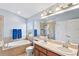Bathroom featuring dual sinks, soaking tub, walk-in shower and natural light at 18061 Glastonbury Ln, Land O Lakes, FL 34638