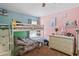 Colorful bedroom with a bunk bed and dresser, offering a vibrant and playful atmosphere at 18061 Glastonbury Ln, Land O Lakes, FL 34638