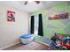 Bright bedroom with a themed décor, ceiling fan, and natural light from the window at 18061 Glastonbury Ln, Land O Lakes, FL 34638