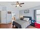 Cozy bedroom featuring modern decor, hardwood floors, and a view of the en suite bathroom at 18061 Glastonbury Ln, Land O Lakes, FL 34638
