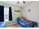 This bedroom features fun wall colors and decorations, ample light, and a single bed at 18061 Glastonbury Ln, Land O Lakes, FL 34638