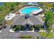 Aerial view of the community clubhouse, pool, and parking lot at 18061 Glastonbury Ln, Land O Lakes, FL 34638