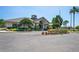 Community clubhouse featuring well-manicured landscaping, an American flag, and ample parking at 18061 Glastonbury Ln, Land O Lakes, FL 34638