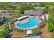Aerial view of the neighborhood pool, playground, and clubhouse, a great place for community fun and relaxation at 18061 Glastonbury Ln, Land O Lakes, FL 34638