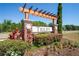 Welcome to Trilby: a community sign surrounded by lush greenery and colorful flowers at 18061 Glastonbury Ln, Land O Lakes, FL 34638