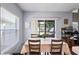 Bright dining area with a large window and sliding glass door, complemented by a cozy dining set at 18061 Glastonbury Ln, Land O Lakes, FL 34638