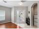 Bright foyer with decorative front door, tile flooring, and a convenient storage closet at 18061 Glastonbury Ln, Land O Lakes, FL 34638