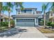 Charming two-story home with a well-maintained lawn and a spacious two-car garage with lush landscaping at 18061 Glastonbury Ln, Land O Lakes, FL 34638