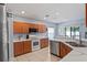 Bright kitchen featuring white marble countertops, wood cabinets, and stainless steel appliances at 18061 Glastonbury Ln, Land O Lakes, FL 34638