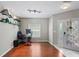 Versatile office space with hardwood floors, shelving, and a decorative front door at 18061 Glastonbury Ln, Land O Lakes, FL 34638
