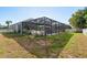 Spacious backyard with screened-in pool, perfect for relaxing and outdoor enjoyment at 1810 Winsloe Dr, Trinity, FL 34655