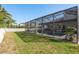 View of the fenced backyard, complete with a screened pool and lush landscaping at 1810 Winsloe Dr, Trinity, FL 34655