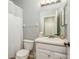Bright bathroom with shower, toilet and vanity sink with open view to the door at 1810 Winsloe Dr, Trinity, FL 34655