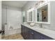 Stylish bathroom featuring double sinks, marble counters, and a tub at 1810 Winsloe Dr, Trinity, FL 34655