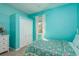 Bright bedroom featuring patterned bedspread, closet and window with sheer curtains at 1810 Winsloe Dr, Trinity, FL 34655