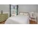 Charming bedroom featuring a cozy bed, vintage dresser, vanity and soft, inviting décor at 1810 Winsloe Dr, Trinity, FL 34655