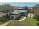 Aerial view of the community clubhouse featuring a covered outdoor area, seating, and lush landscaping at 1810 Winsloe Dr, Trinity, FL 34655