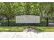 Elegant community entrance sign for Fox Wood at Trinity Park, surrounded by lush landscaping and mature trees at 1810 Winsloe Dr, Trinity, FL 34655