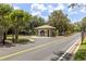 Gated community entrance with a guardhouse and well-maintained landscaping at 1810 Winsloe Dr, Trinity, FL 34655