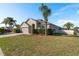 Charming home exterior with well-manicured lawn, mature landscaping, and inviting curb appeal at 1810 Winsloe Dr, Trinity, FL 34655